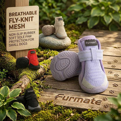 Breathable fly-knit dog shoes resting on a wooden path, designed with soft rubber soles to protect small dogs' paws during outdoor walks.