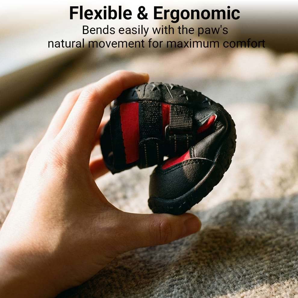 Hand bending the flexible dog shoes sole to show ergonomic design that moves naturally with the paw for maximum comfort.