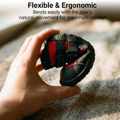 Hand bending the flexible dog shoes sole to show ergonomic design that moves naturally with the paw for maximum comfort.