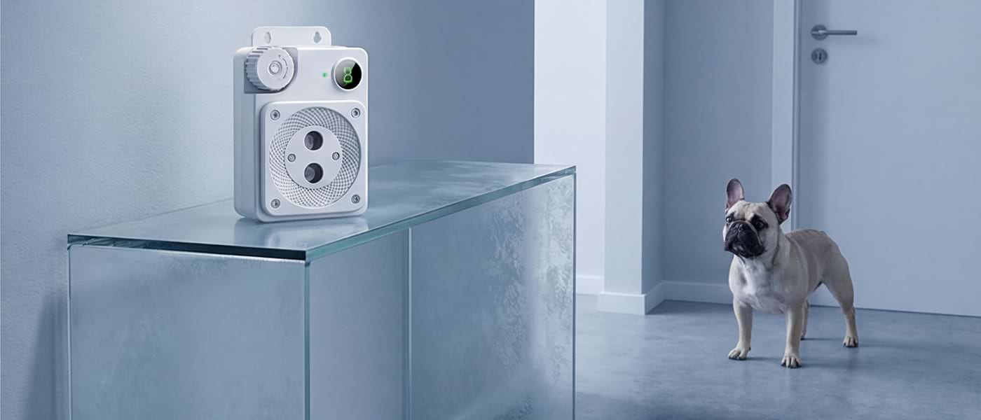 Sleek, modern Smart Dog Barking Device on a glass shelf. Perfect for small breeds like French Bulldogs, blending perfectly with modern interior design.