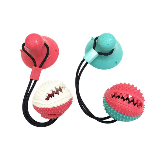 Suction Cup Dog Toy in vibrant red and cyan, featuring a durable tug rope and a dental chew ball for interactive solo play.